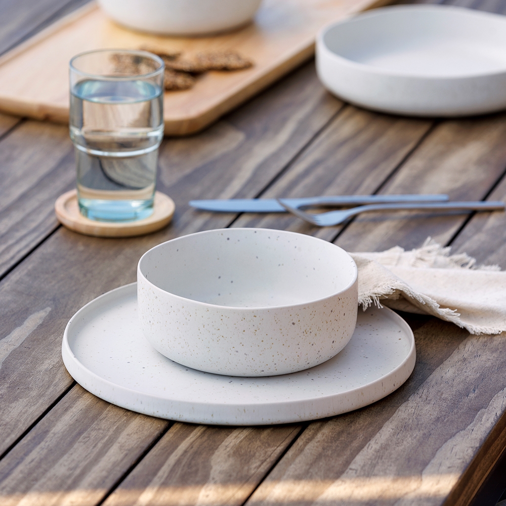 Ecology Domus recycled stoneware dinner setting on an outdoor wooden table next to Habitat recycled glasseware.